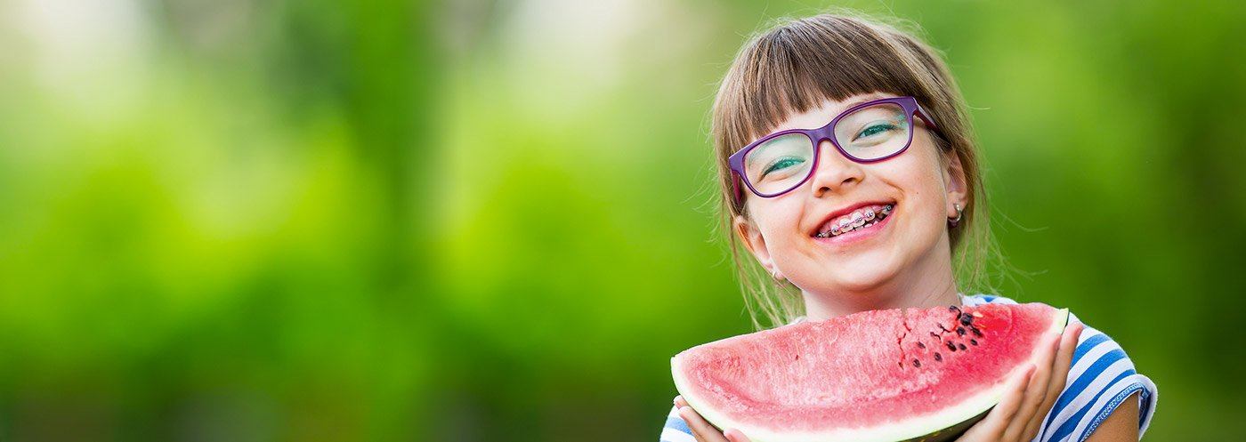 Smiling girl holding a watermelon