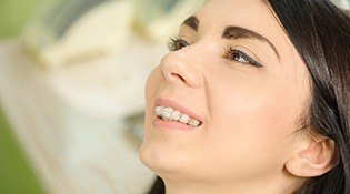 Smiling woman with ceramic braces