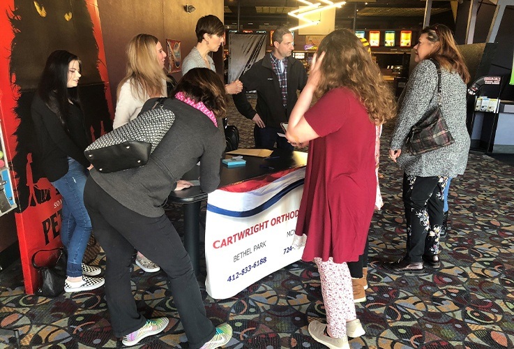 Cartwright orthodontics information table at community Involvement movie theater event