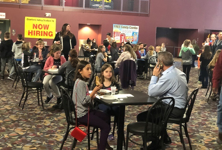 Families enjoying community Involvement movie theater event