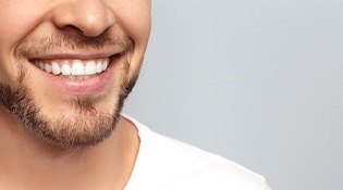 Man smiling on gray background