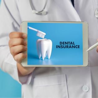 Doctor holding tablet with dental insurance information