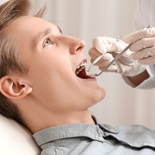 Young man with braces visiting his orthodontist