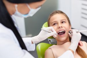 young girl gets a dental exam