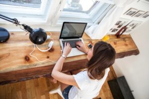 A woman using a laptop.