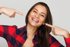 woman smiling wearing metal braces