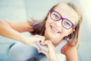 young girl smiling wearing braces