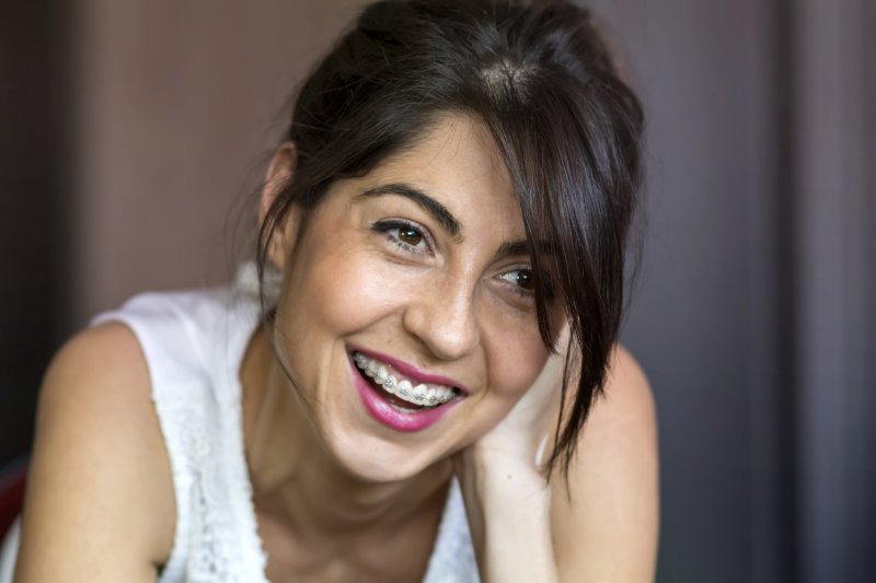 Adult woman smiling with braces