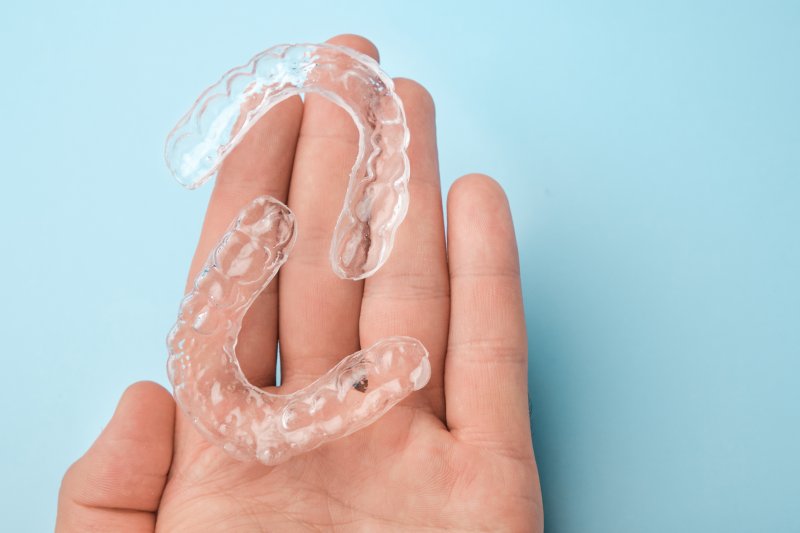 clear aligners in a person’s hand