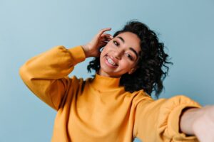 A woman with braces taking a selfie